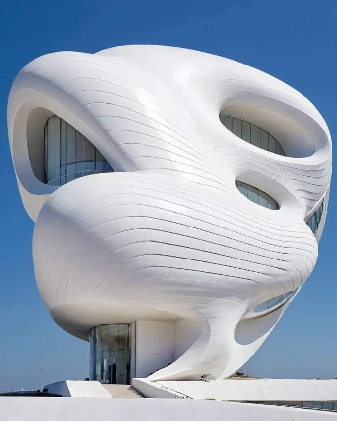 Futuristic building with smooth, curved surfaces and intricate details created using AI architectural modeling.