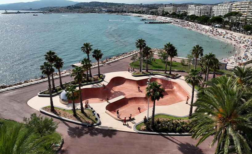 "Aerial view of Cannes showing the skatepark nestled between gardens and the sea."
