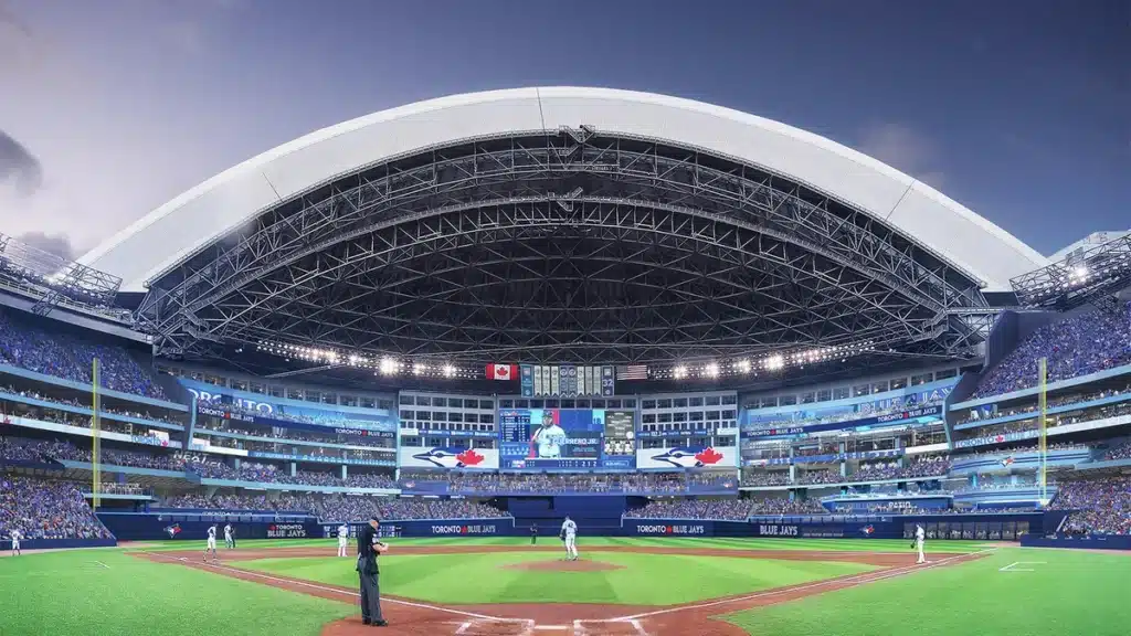 A baseball stadium with a partially open retractable roof, viewed from behind home plate