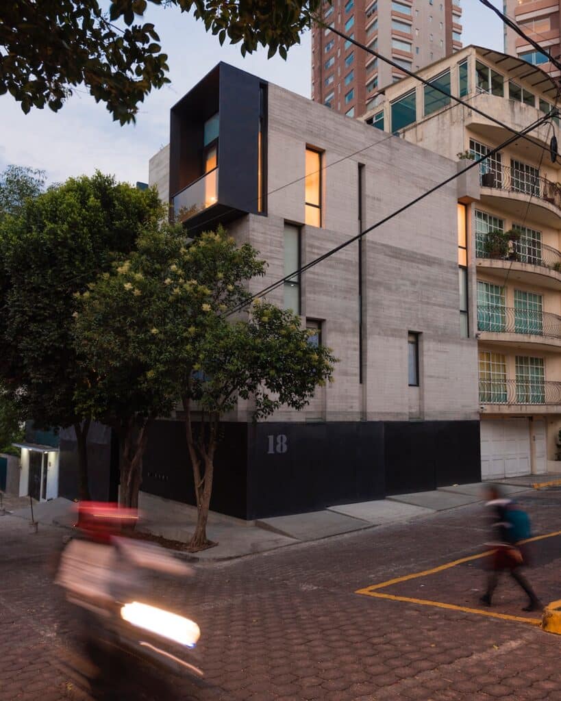 Exterior view of Cuajimalpa residential project at sunset with street traffic
