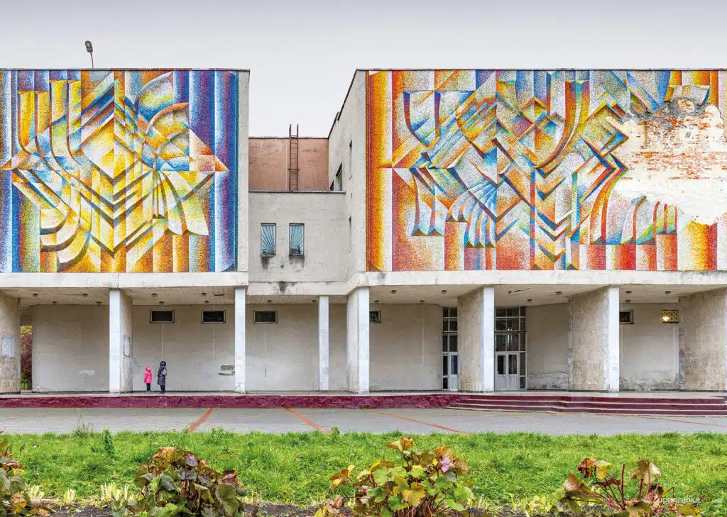 A school building facade with vibrant mosaics, representing public art in modern architecture.