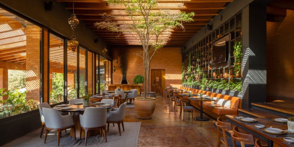 "Restaurant at Hotel Avándaro featuring a design that blends nature and comfort with natural ceiling lighting."