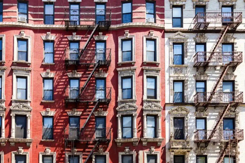 "A row of colorful apartment buildings with fire escapes, illustrating the importance of second engineering opinions in ensuring structural safety and design integrity."