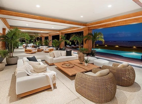 Single-level oceanfront residence in Kahala with retractable glass walls and tropical landscaping.