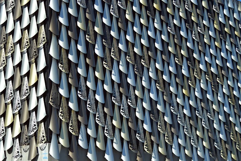 A 3D architectural model showcasing a complex and innovative design using BIM technology, featuring an intricate arrangement of interlocking geometric components in a visually striking pattern.