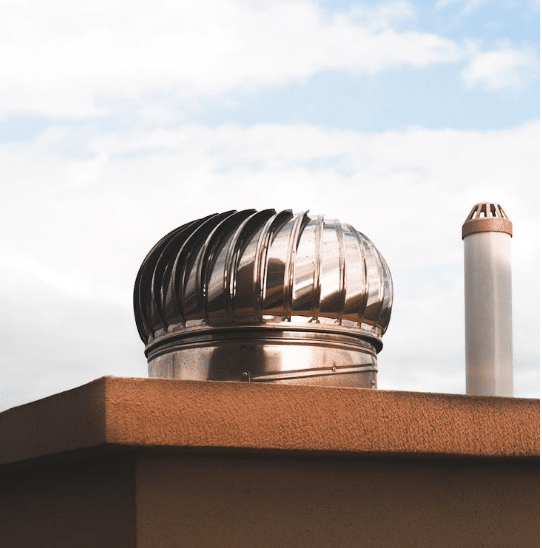 A passive stack ventilation system on the roof, designed to naturally ventilate upper floors using wind and thermal differences.