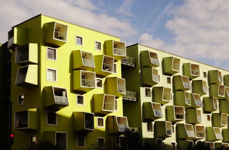 A modern building in Copenhagen with vibrant green and yellow facades, representing sustainable architecture."