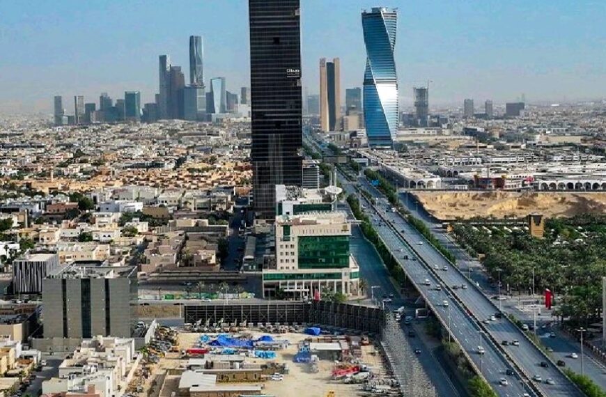 An aerial view of the Ajdan Towers under construction in Riyadh, featuring active construction equipment and site activity, with a backdrop of the city's modern skyline.