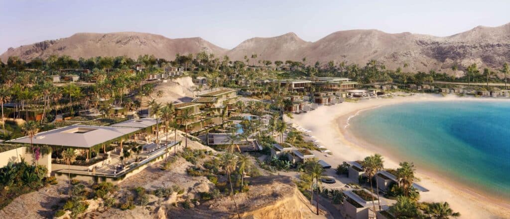 Amaala luxury resort on the Red Sea, showcasing modern white structures overlooking a pristine sandy beach and crystal-clear turquoise waters.