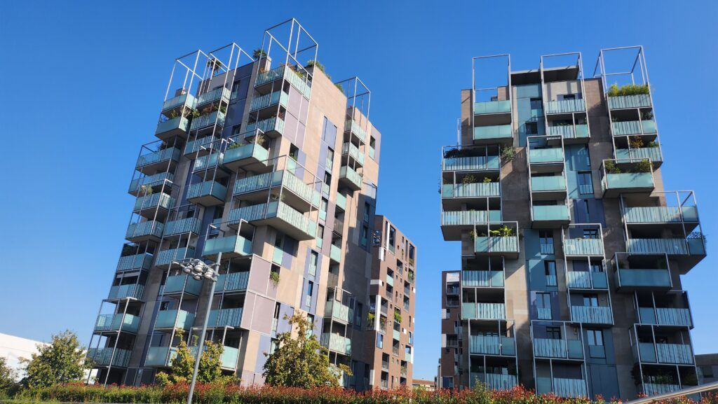 Modern residential buildings in Milan showcasing innovative design that integrates nature with urban architecture.