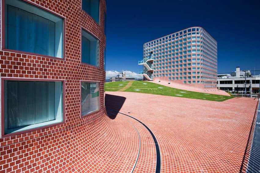 "Architectural design by Riken Yamamoto, integrating vibrant colors with open spaces."