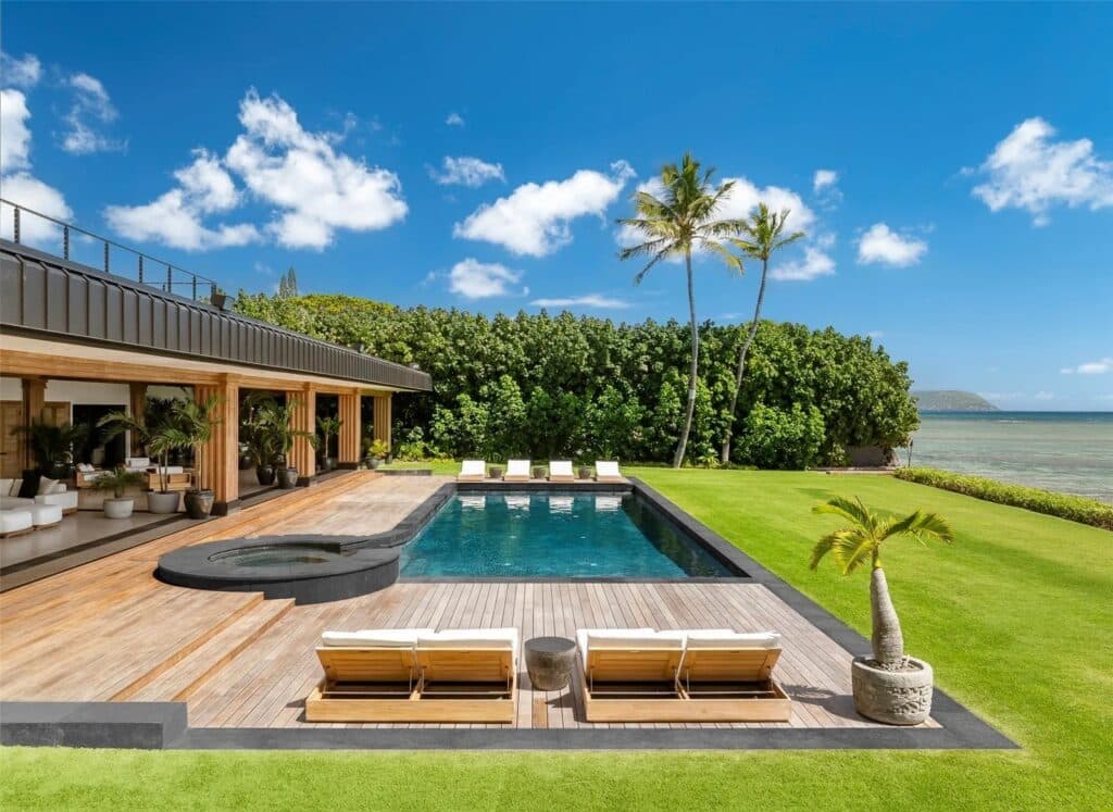 Oceanfront luxury home in Kahala with glass walls and tropical landscaping