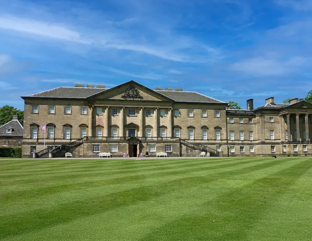 "English country house showcasing classical architecture with expansive gardens"