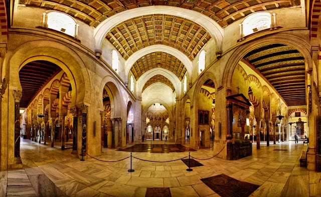"Gothic cathedral inside the Cordoba Mosque, surrounded by Islamic arches."