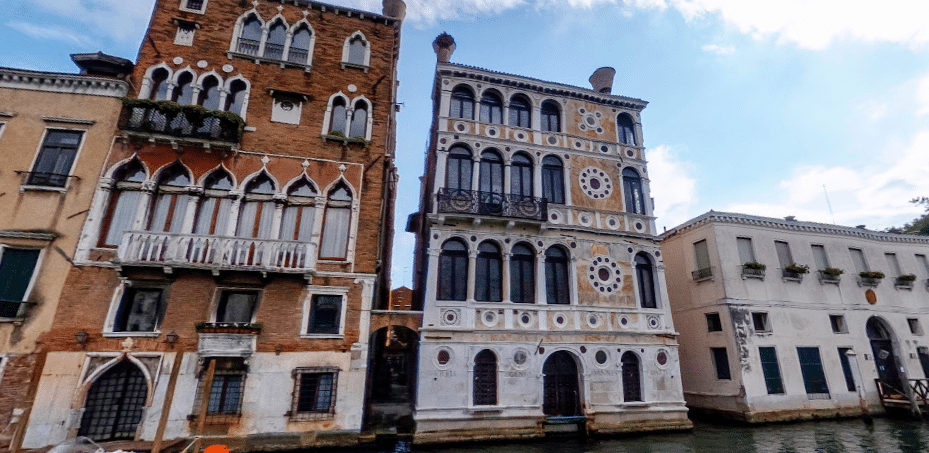 Traditional Italian buildings along canal waters, associated with ghostly legends.