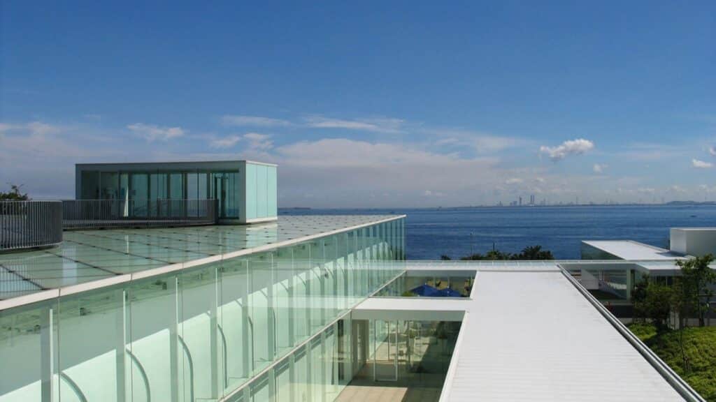 "Architectural design by Riken Yamamoto, integrating transparent glass with stunning sea views."