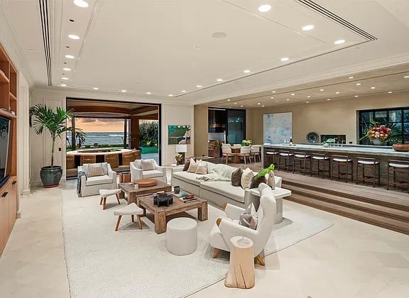 Single-level oceanfront residence in Kahala with retractable glass walls and tropical landscaping.