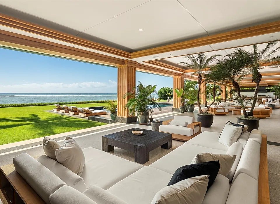 Single-level oceanfront residence in Kahala with retractable glass walls and tropical landscaping.