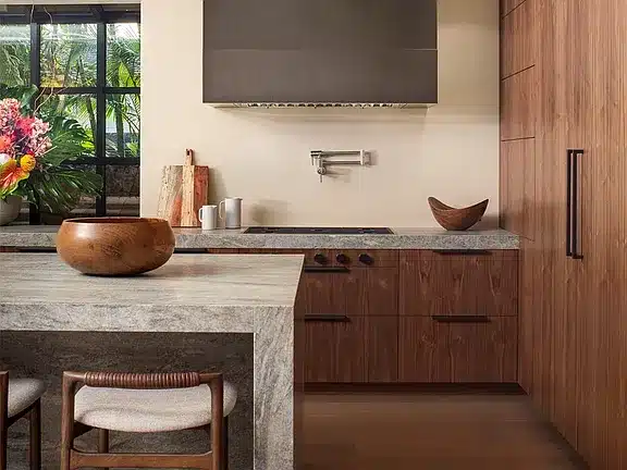 Single-level oceanfront residence in Kahala with retractable glass walls and tropical landscaping.

