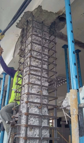 A reinforced concrete column showing visible cracks, with a well-connected steel rebar grid to enhance structural strength