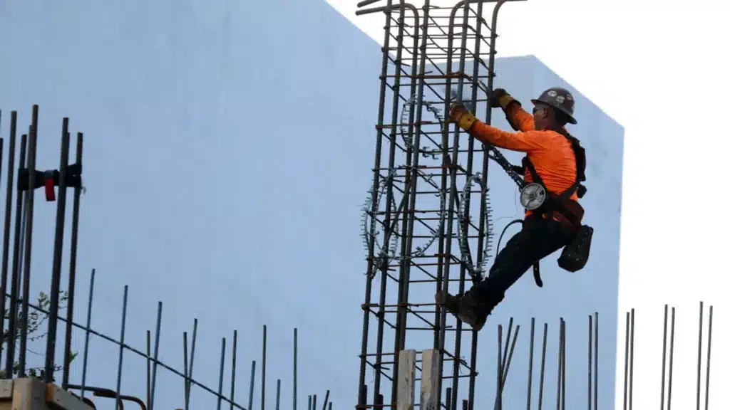 A construction worker supports the implementation of the Buy American Act in building projects.







