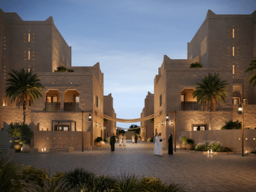 Image of the entrance to the Armani Residences project in Diriyah, showcasing Najdi heritage-inspired architecture with stone buildings and surrounding palm trees, with people strolling in the evening.