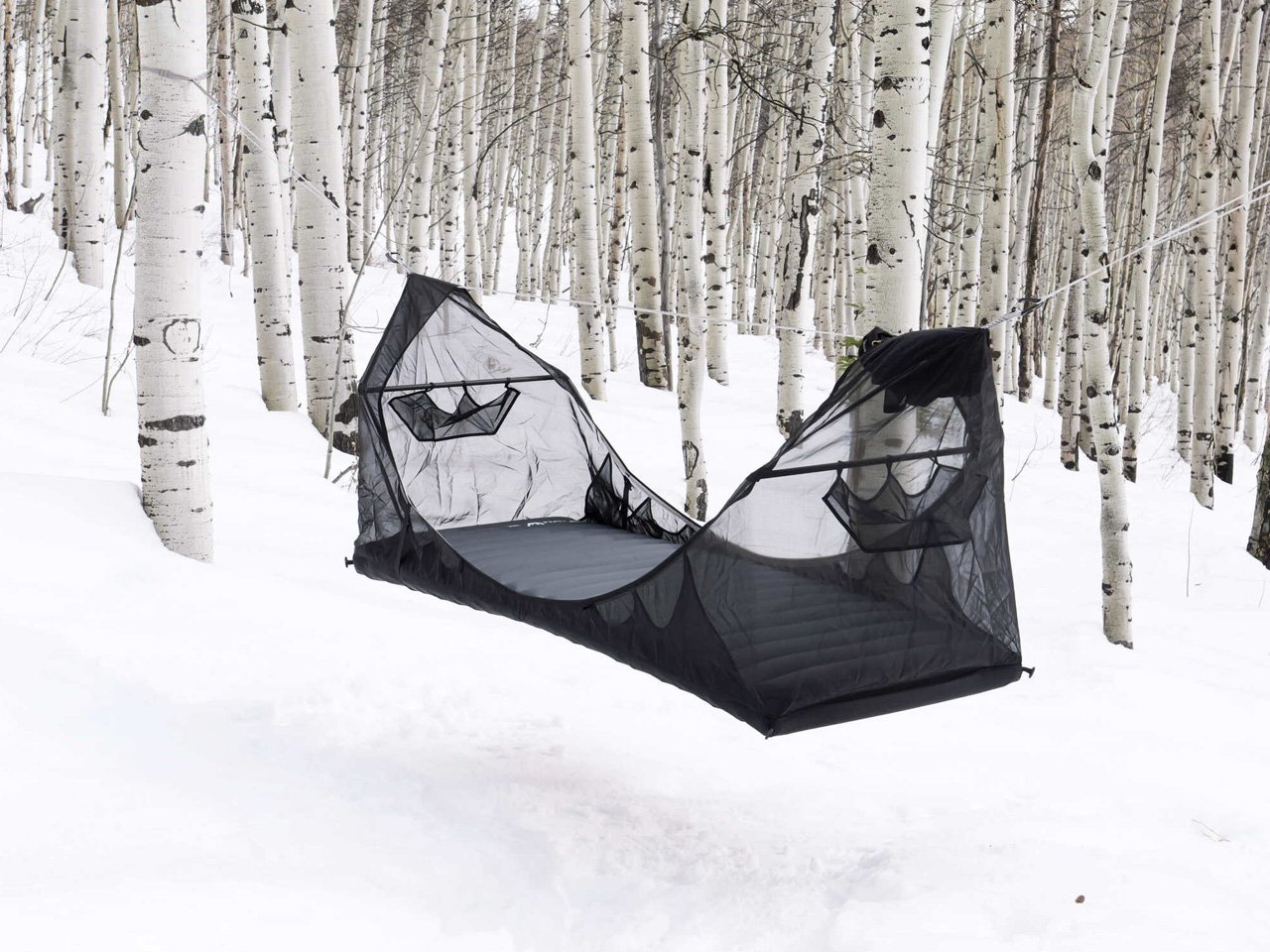 Haven Spectre hammock set up in a forest with trees