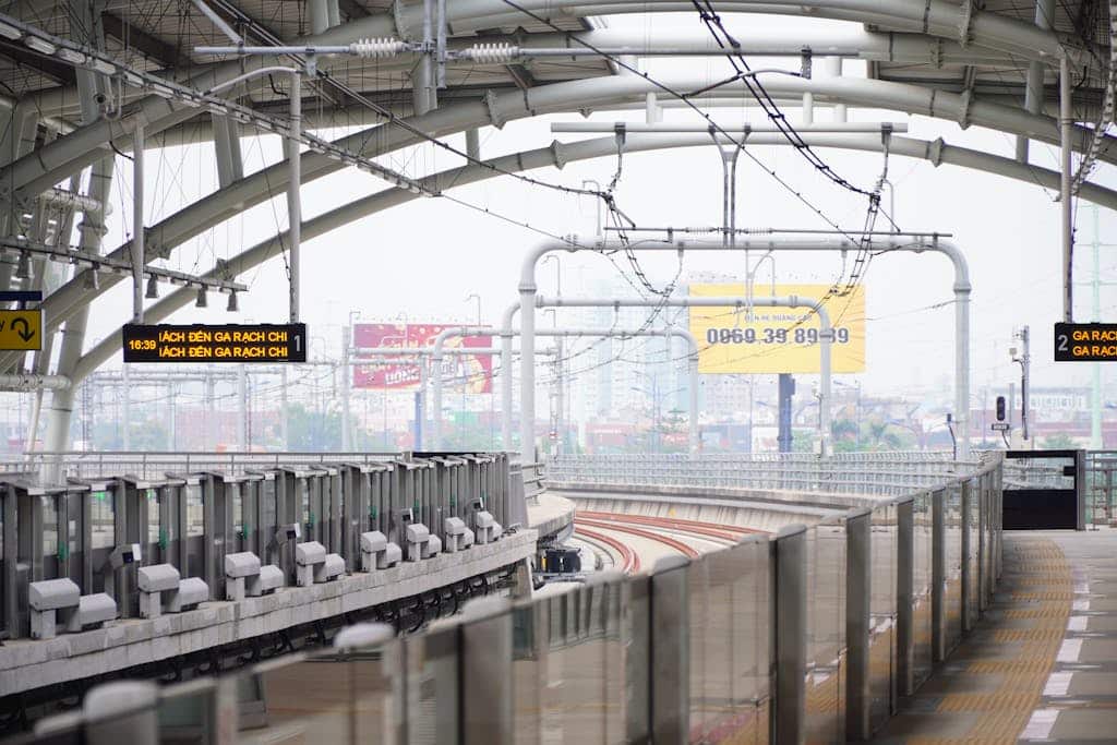 A modern urban train station featuring sleek curved roofs and empty platforms, highlighting contemporary architectural design.
