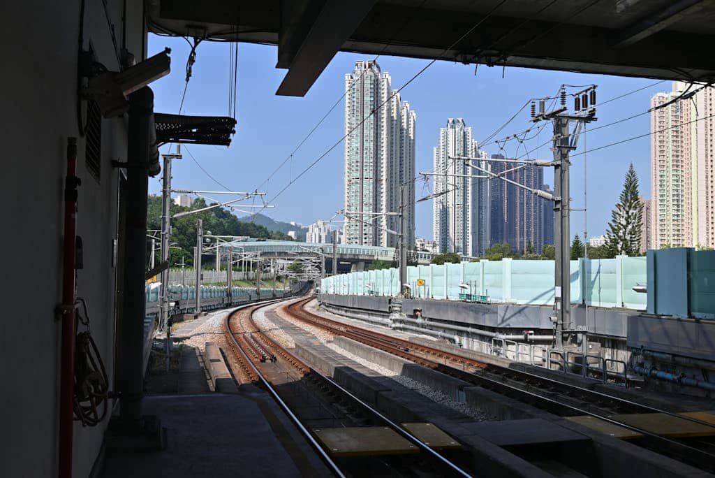 Curved train tracks winding toward a modern city skyline, illustrating advanced urban infrastructure.