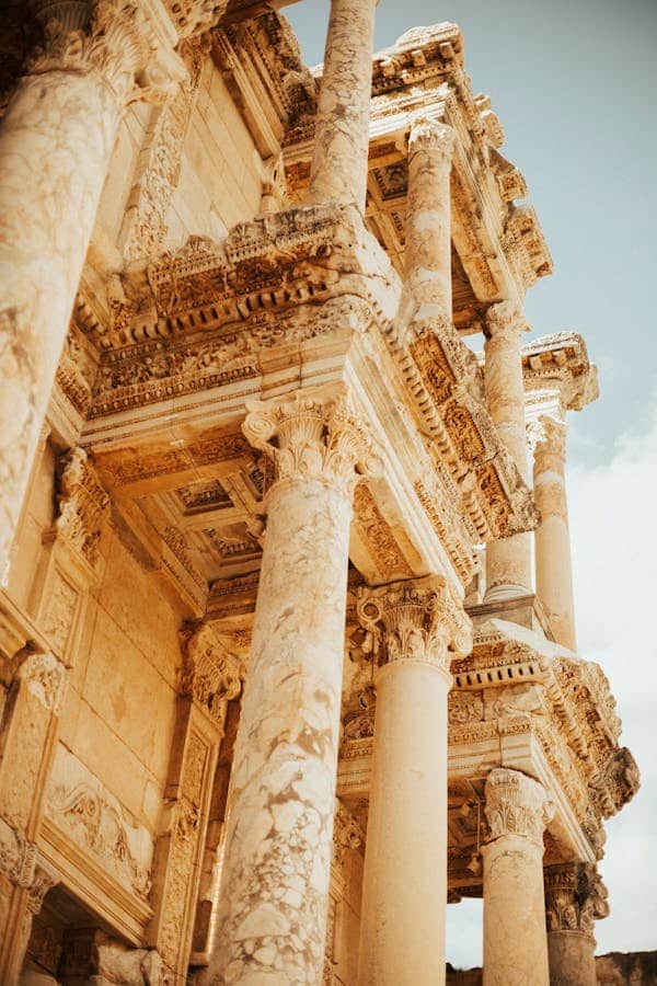 Classical limestone columns forming part of a historic building, with intricate carvings that showcase the artistic beauty of ancient engineering.