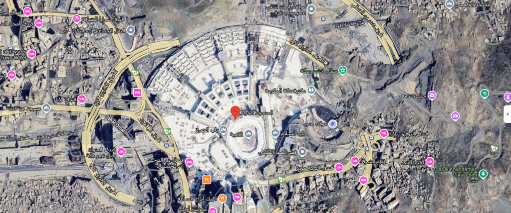 An aerial view of the Grand Mosque area in Mecca, highlighting Al-Safa Palace. The palace is located above the Sa’i area between Mount Safa and Mount Marwah, with a strategic position offering a direct view of the Kaaba. Its modern design features reflective glass facades and earthy tones that blend seamlessly with Mecca's rugged terrain, making it a crucial spiritual and political center during Ramadan and the Hajj.