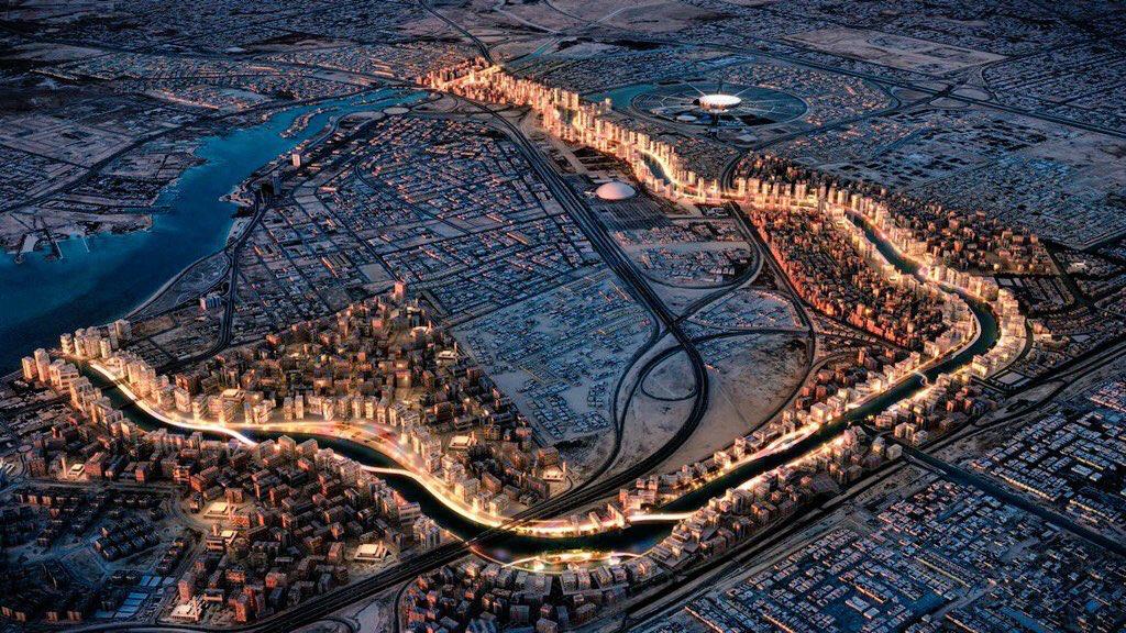 Aerial night view of the Marafy masterplan in northern Riyadh, showing the water canal route surrounded by planned buildings.