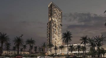 A modern residential tower with large glass windows, surrounded by palm trees in its vicinity.