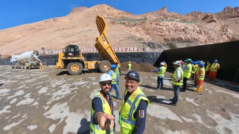 Workers in safety vests operate among heavy machinery at the Trojena Dam site, as groundwork preparation gets underway.