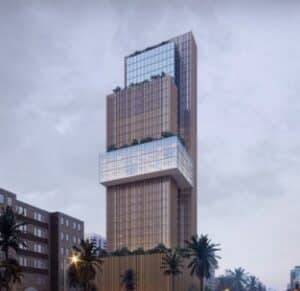 Modern glass facade of Skyline Tower in Al Muruj, Riyadh, reflecting the sky and surrounding palm trees.