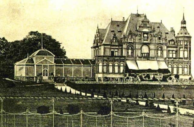 The historic Carl Ziese Villa overlooking the Elbląg River, featuring arched windows and classical details that showcase European architectural beauty.