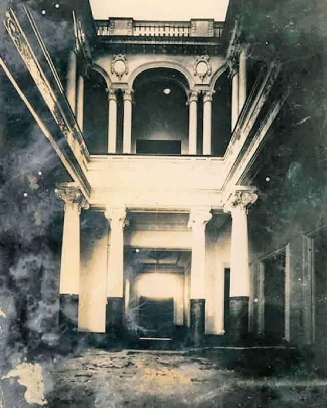 The entrance of the historic Baca House, showcasing classical columns and intricate architectural details.