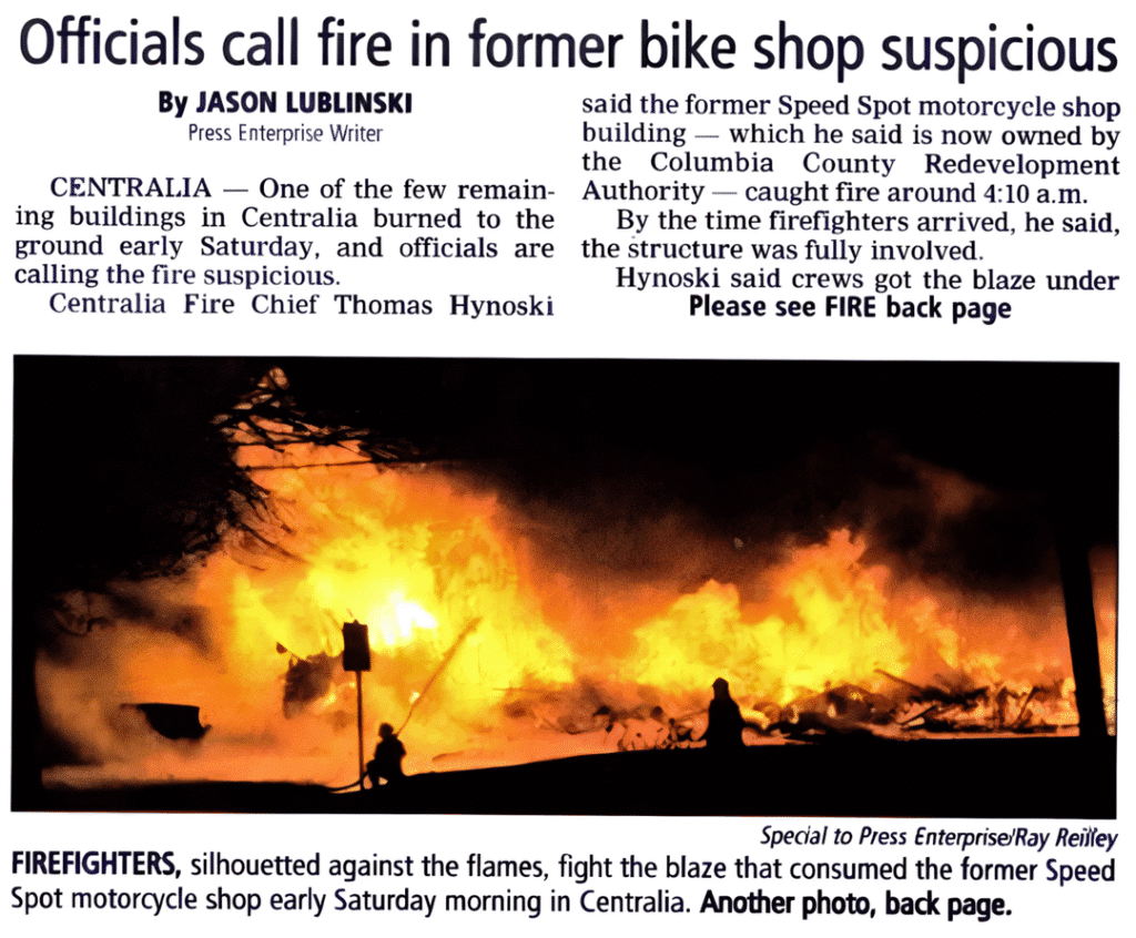 A newspaper clipping with a headline about the suspicious fire at The Speed Spot, featuring an image of intense flames engulfing the building.