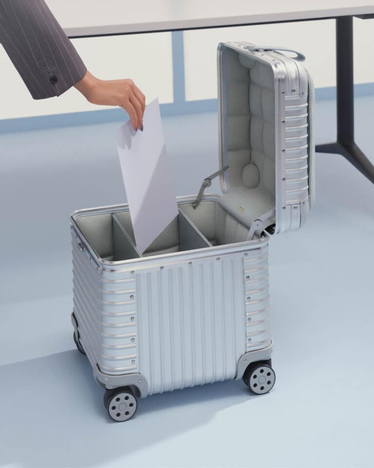 Hand putting papers into an open aluminium storage box