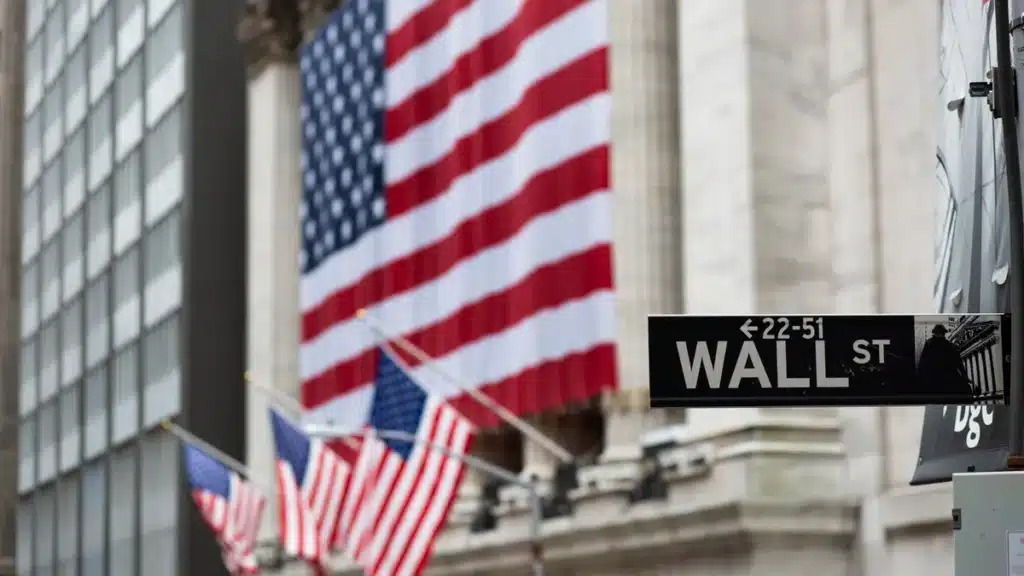 The American flag waves in front of a government building, reflecting the atmosphere of political shifts and their impact on the future of projects in the infrastructure sector.