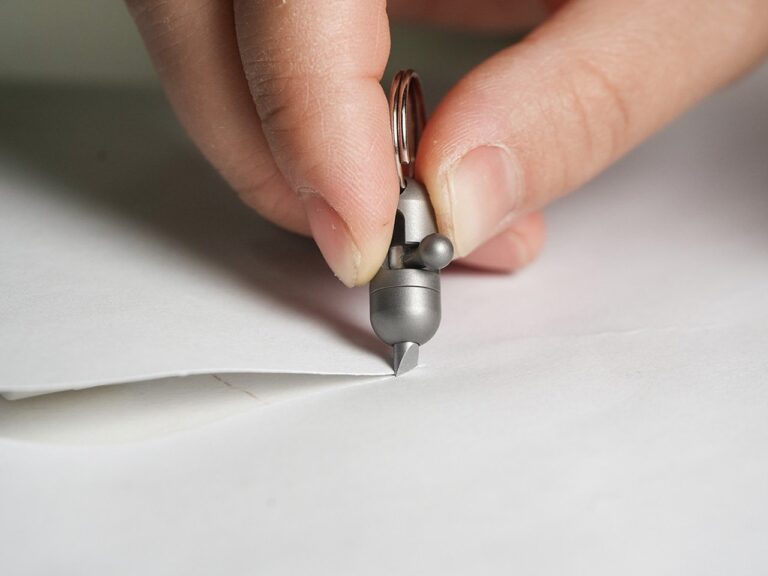 This Pill-Sized PeaCut Titanium EDC Cutter Makes Short Work of Big Packages