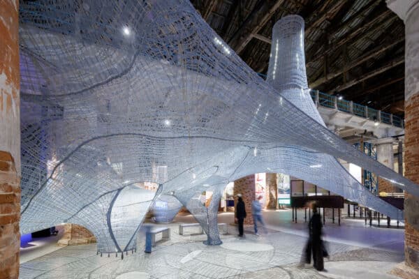 Overview of the suspended Necto installation inside the Arsenale in Venice, made from three-dimensional natural fibers.