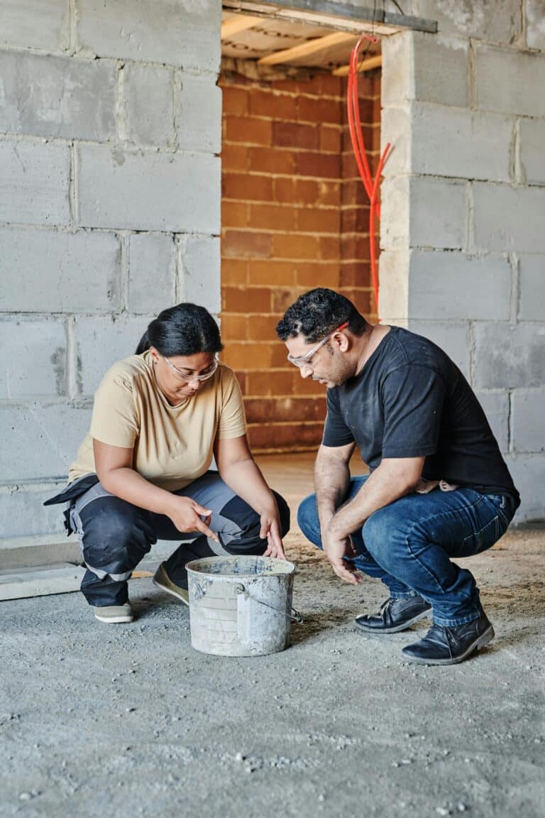 Engineers studying advanced construction materials within the scope of atomic material transformation