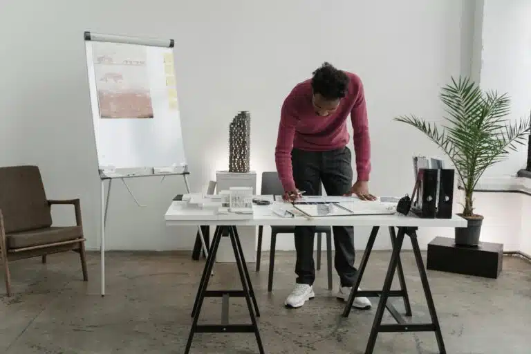 A professional engineer from WSP reviews detailed engineering drawings, reflecting WSP company’s outstanding performance in managing and executing complex engineering projects.
