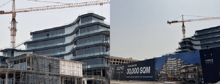 Image showing the active construction progress of the Soho Square project in Jeddah, with visible steel structures and towering cranes working on the building. The project spans approximately 30,000 square meters and features a reflective glass facade.