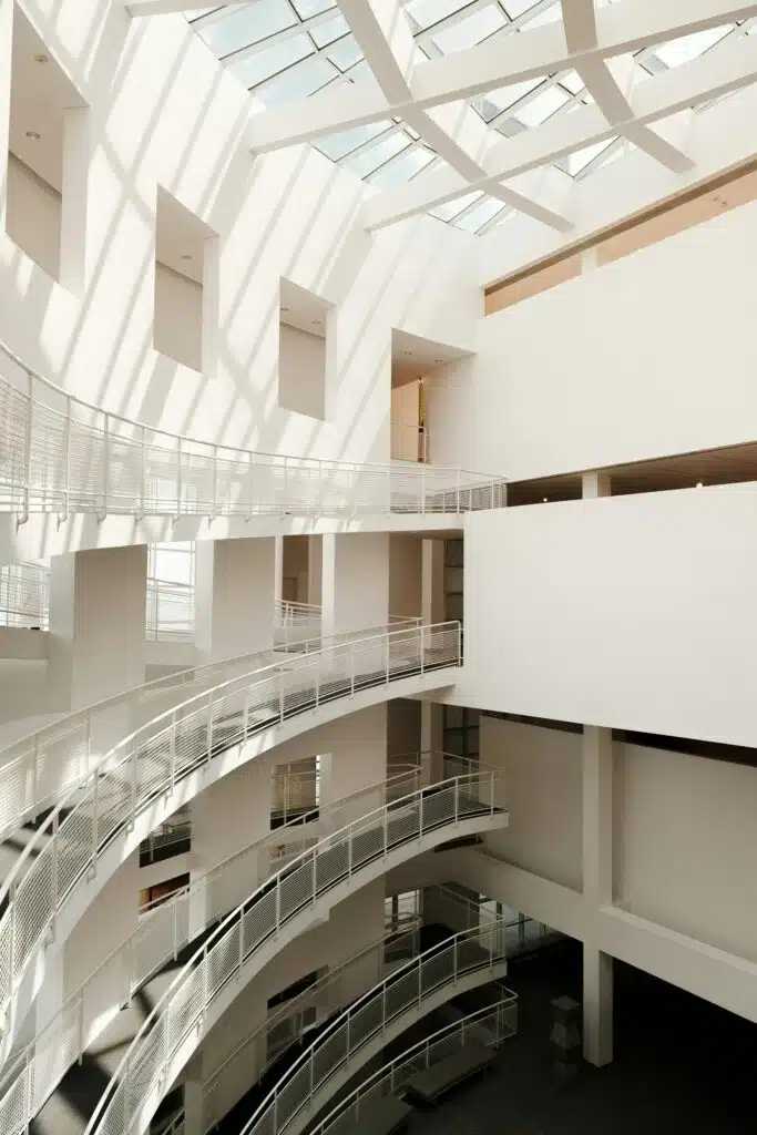  An interior space with exposed concrete surfaces and natural light streaming from above