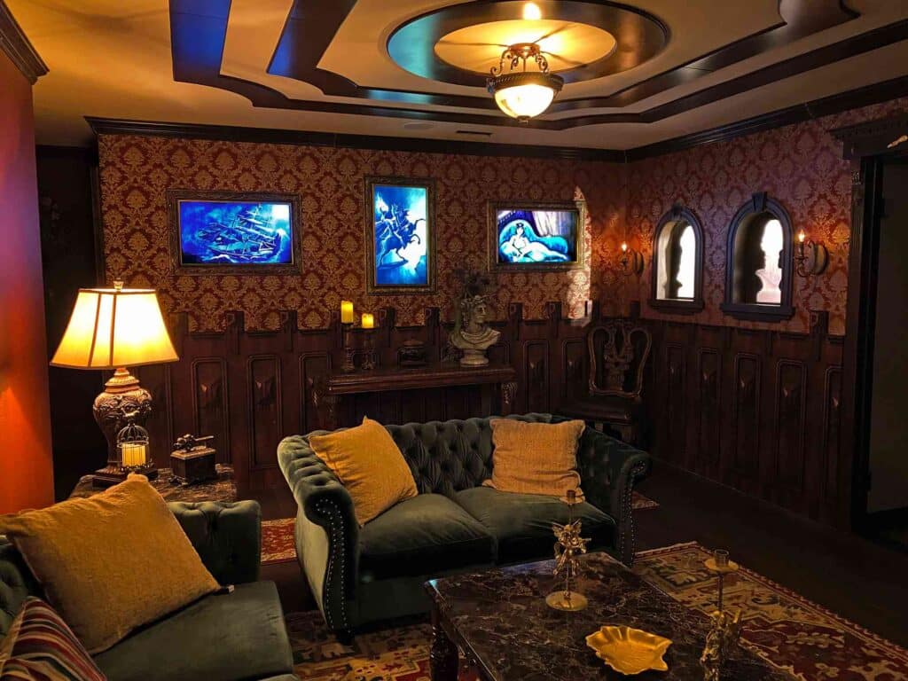 A dark room inspired by haunted house aesthetics, featuring classic decor and dim lighting.