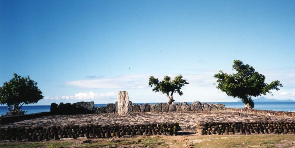 Image of a traditional marae complex in Raiatea Island, showing a sacred stone platform surrounded by an open courtyard used for spiritual rituals.