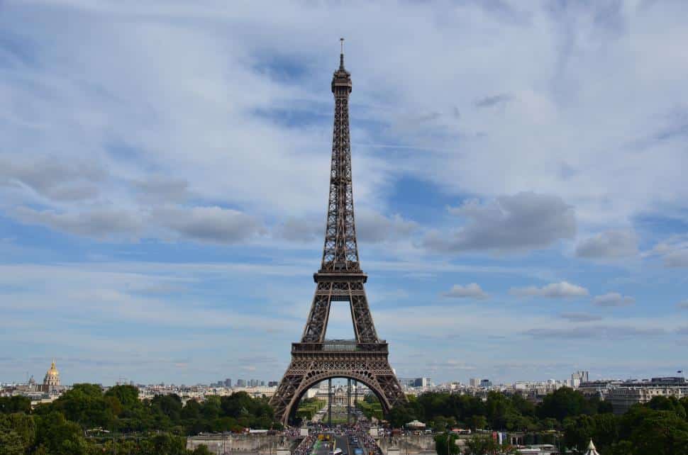 A photo of the Eiffel Tower at sunset, standing tall above the Paris skyline and reflecting its iconic presence.