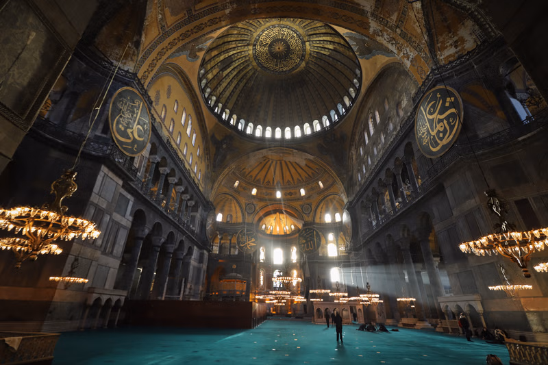 Interior view of the grand dome, windows, and decorations inside Hagia Sophia